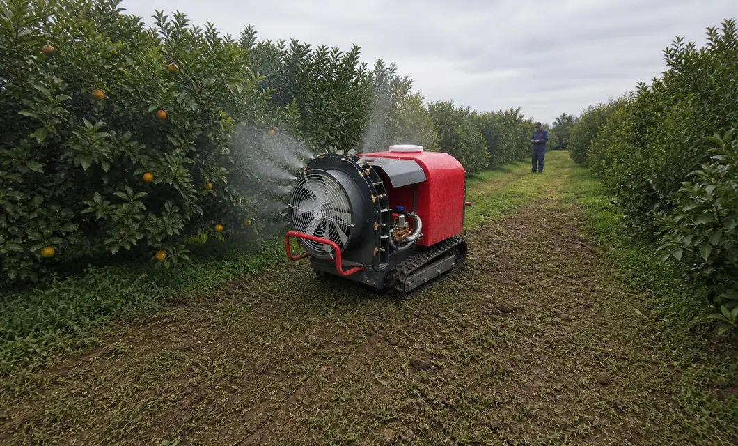 Remote unit follows citrus lanes for even foliage spray.