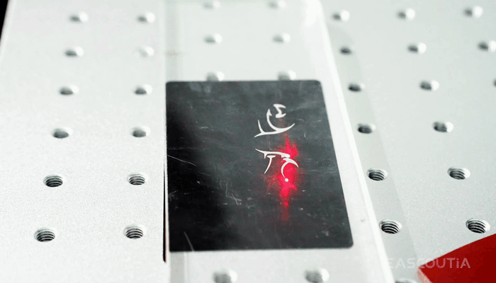 English Copy: Bright silver patterns cut cleanly into dark stainless surfaces.