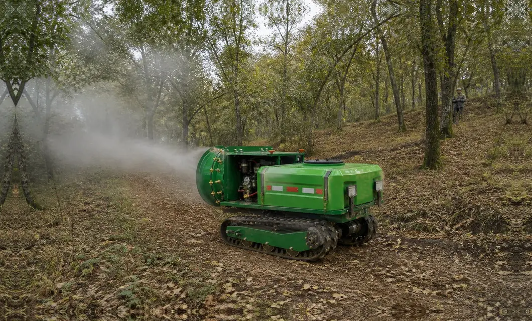 Crawler unit sprays woodland trees on leaf-covered slopes.
