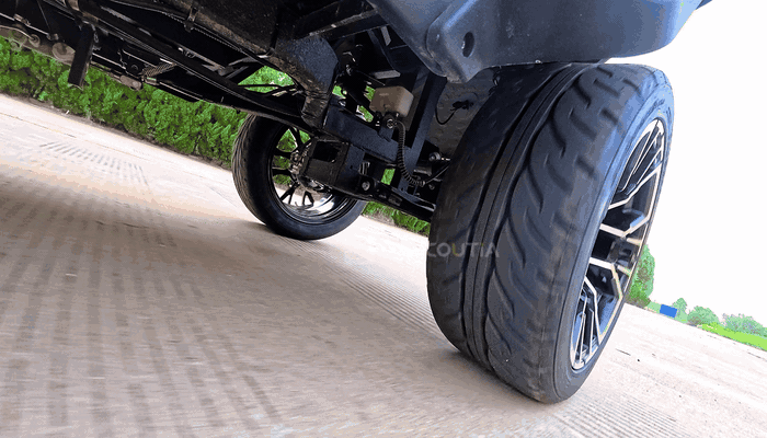 Wheel and underbody movement stay visible on the road.