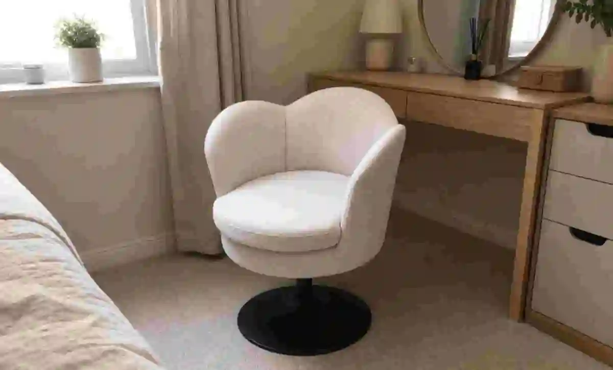 Small upholstered lounge chair beside the bed for guest rest.