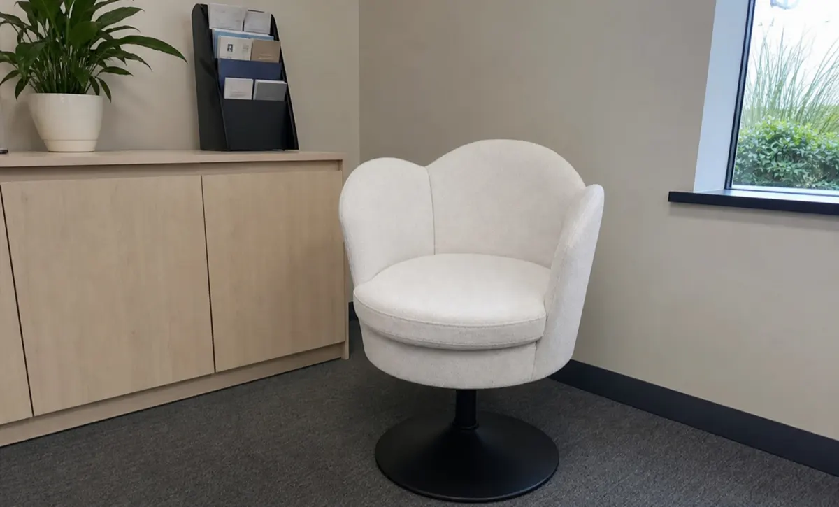 Soft waiting seat in an office reception area for visitor pauses.