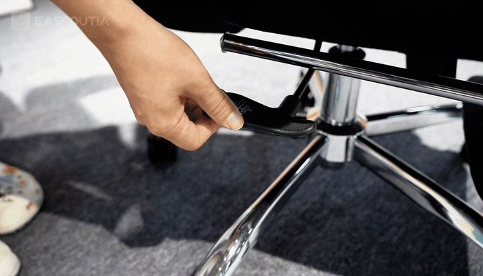 A height adjustment lever beneath the seat changes the chair height when operated by hand.
